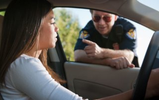 Female driver pulled over by male police officer.