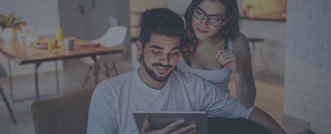 A couple in the kitchen looking at a tablet