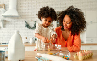 Mom and daughter cooking together in kitchen