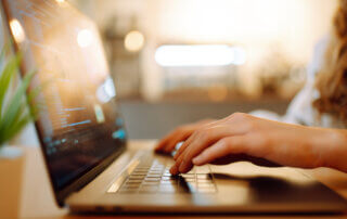 Female hands working on a laptop