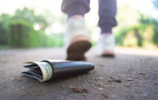 Man walks away from his wallet on the ground